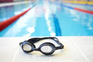 Image of swimming pool and goggles. Nobody